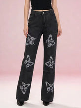Black denim butterfly print wide-leg jeans featuring a bold light gray stylized butterfly design and high-waisted fit