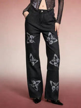Black denim butterfly print high-waisted wide-leg jeans with stylized white butterfly designs on the front
