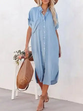 Light blue denim midi shirt dress with short sleeves and button front in a casual shirt dress style