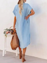Light blue loose-fitting denim midi shirt dress with short sleeves and asymmetrical hemline for casual wear