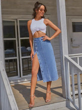 Light blue denim skirt with front button closure and high slit made from machine wash cold fabric