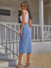 A light blue button down denim skirt with high waist and side pockets made from machine wash cold fabric