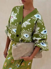 Olijfgroene cardigan met verlaagde schouders en oogmotieven