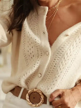 Cream-colored eyelet cardigan with openwork design and metallic buttons