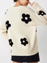 Cream-colored soft knit floral applique cardigan with black fluffy flowers