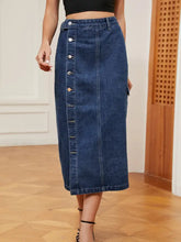 Button down midi denim skirt in blue with mid-thigh length, central button closure, and subtle side pockets