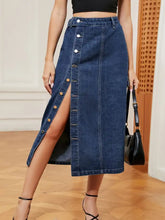 Button down midi denim skirt in blue with mid-thigh length, front button closure, and side slit detail