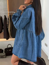Blue denim mini denim dress with button down front pockets and relaxed fit featuring smocked cuffs