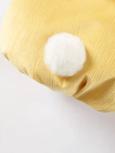 Fluffy white pom-pom on yellow ruffle collar of pet jumpsuit