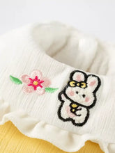 White ribbed ruffle collar on pet jumpsuit with pink cherry blossom and bunny patch