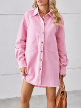 Pink denim dress with button front chest pockets and raw hem in a button-down raw hem denim dress style