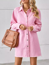 Pink button-down denim dress featuring a raw hem and button front made from soft denim fabric