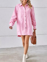 Pink raw hem denim dress with button front and two chest pockets in a button-down raw hem denim style
