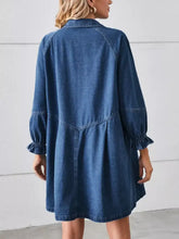 Button down medium-wash blue denim dress with long sleeves and ruffle cuff detail suitable for machine wash