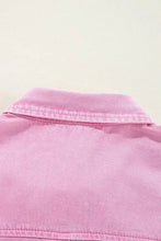 Close-up of pink denim jacket collar on short sleeve denim dress showcasing button down design and fabric texture