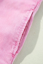 Pink button down short sleeve denim dress with subtle ribbed texture and neatly stitched seams in denim fabric