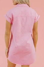A soft pink short sleeve denim dress with rolled-up sleeves and a buttoned collar in denim fabric
