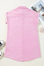 A soft pink short sleeve denim dress with button down front collar and comfortable denim material