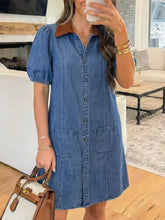Button-down short sleeve blue denim dress with brown collar and two pockets machine wash cold for easy care