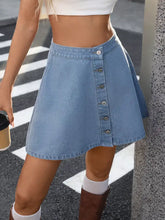 Light blue button-front a-line denim skirt featuring a classic button design in soft denim material