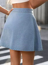 Light blue button-front a-line denim skirt with a flared silhouette and fitted waistband in denim material