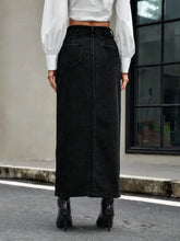 Black denim skirt with high waist and two back pockets shown from the back in a button front denim skirt design