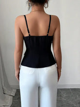 Black satin fitted cami with thin straps and a peplum silhouette featuring a button-front design