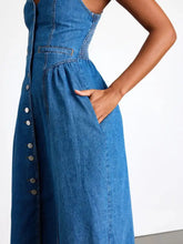 A blue midi denim dress with button-front closure and side pockets made from durable denim fabric