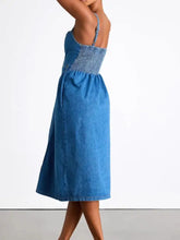 Blue midi denim dress with smocked bodice and thin straps in button-front midi denim dress style
