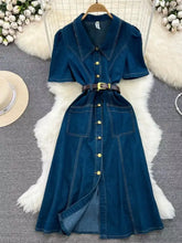 Deep blue short sleeve denim dress with collar front button closure and two large patch pockets