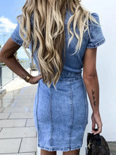 Blue denim dress with button front, short sleeve denim style, and fitted silhouette perfect for casual wear
