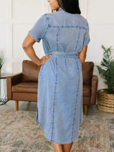 Light blue short sleeve denim dress with button front and belted waist for a stylish casual look