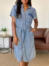 Light-wash short sleeve denim dress with button front closure and tied waist belt in a sleeve denim dress style