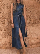 Sleeveless denim dress with button-front design, belt tie waist, and layered ruffle hem in blue denim fabric