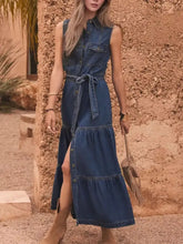 Blue denim sleeveless dress with button front, tiered skirt, and tied waistband perfect sleeveless denim dress