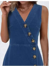 Blue sleeveless denim dress with v-neck and diagonal gold-toned button closure for stylish casual wear