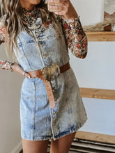 Light-wash button front square neck denim dress styled with floral long-sleeve top and brown leather belt