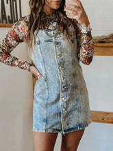 Light-wash button front square neck denim dress styled with floral long-sleeve top featuring a neck denim dress design