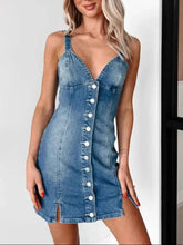 A fitted denim mini dress with thin straps white buttons and a plunging sweetheart neckline
