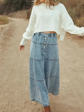 Button-front tiered maxi denim skirt in light-wash denim with patchwork paneling and maxi length design