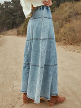 Light-wash denim skirt with button-front and tiered panels in a relaxed flowing maxi denim skirt silhouette
