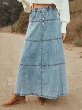 A light-wash button-front tiered maxi denim skirt with elastic waistband in maxi length denim skirt style