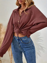 A dusty rose waffle knit button-front polo sweatshirt with long sleeves and collar machine wash cold