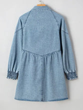 Light blue denim shirt dress with long sleeves and smocked cuffs in a button-up denim shirt style