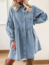 Light blue denim shirt dress with puff sleeves smocked cuffs and button front design in denim material