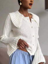 White ribbed knit flare sleeve cardigan with wide collar and pearl buttons