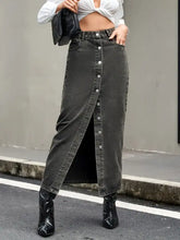Dark gray high rise denim skirt with front button closure and side slit in a midi length denim skirt style