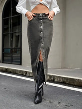 Dark gray high rise denim skirt with front button closure and thigh-high slit in durable denim fabric