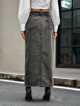 Back view of a long dark gray high rise denim skirt with two pockets made of denim material