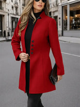 A vibrant red button up long sleeve tailored coat with black buttons and a sleek collar for stylish wear